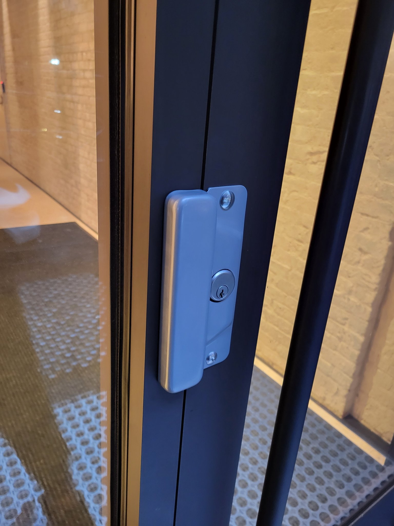 Brass entry hardware serviced on a classic East Village door.