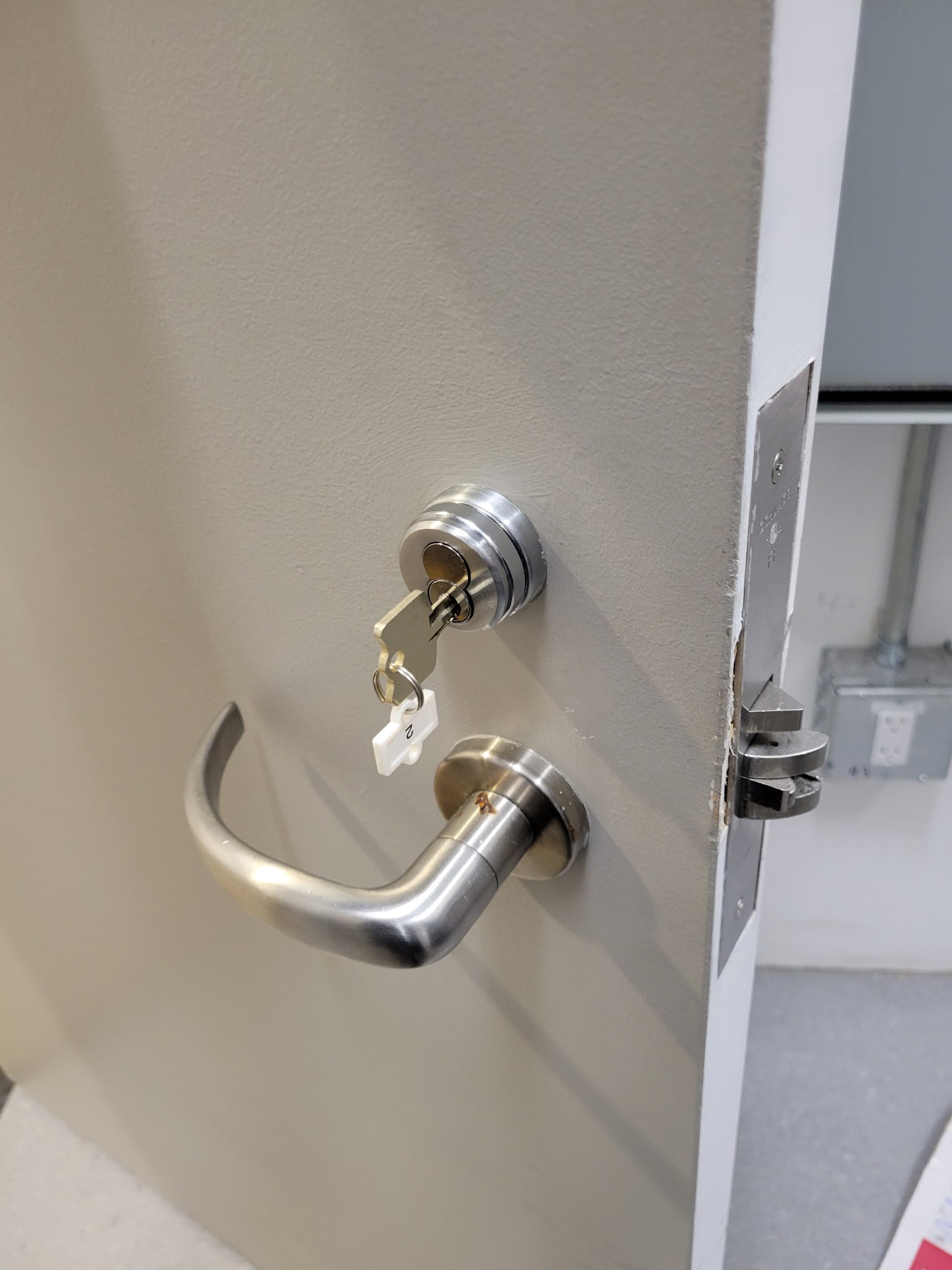 Storefront door hardware: lock and closer serviced for daily traffic.